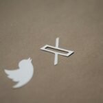 a white twitter logo and a white twitter sticker